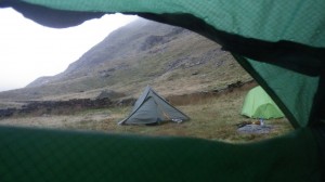Wild camping on the south side of Snowdon. Assessing the morning weather before adventuring out
